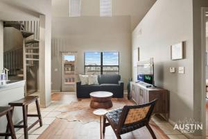 a living room with a couch and a table at Balcony Views and Ideal West Campus Austin Location in Austin