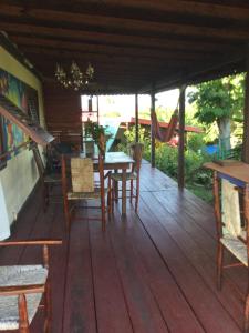a porch with a table and chairs and a hammock at NEW- Rodney Bay two bedrooms BEST VIEW 6 in Gros Islet