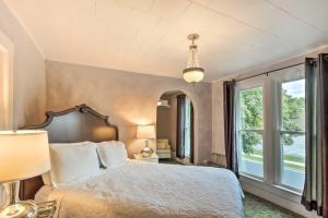 a bedroom with a bed and a large window at Dog-Friendly Home with Balcony and Yard in Surgeon Bay in Sturgeon Bay
