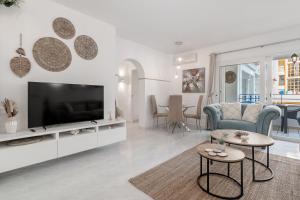 a living room with a flat screen tv on a entertainment center at Apartamento mediterráneo en el alma de Moraira in Moraira