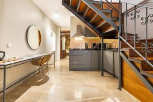 a kitchen with a staircase and a sink and a counter at Mesmerizing Flat near Hadrians Gate in Antalya