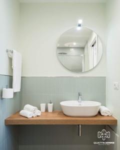 a bathroom with a sink and a mirror at Atlantis Home in Cagliari