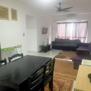 ein Wohnzimmer mit einem schwarzen Tisch und einem Sofa in der Unterkunft Homestay Danau Ria @ Gamuda Gardens in Pengkalan Kundang