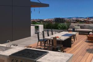 a patio with a table and chairs on a roof at Unique loft con piscina cerca a parque 93 in Bogotá
