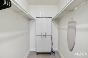 a white closet with a skateboard on the wall at Cozy Newly Renovated King Sofa Bed and Smart TV in Austin