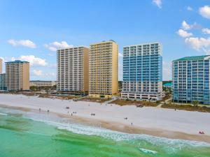a beach with tall buildings and people on the beach at Twin Palms 1705 in Panama City Beach