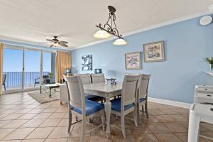 a dining room with a table and chairs at Twin Palms 1705 in Panama City Beach