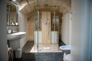 a bathroom with a shower and a toilet and a sink at Residence Le Vie Del Mosto in Matera +43 photos