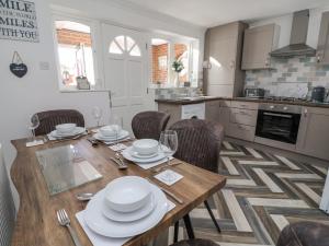 a kitchen and dining room with a wooden table and chairs at 2 Rowan Walk in Hornsea