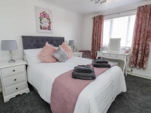 a bedroom with two beds with towels on them at 2 Rowan Walk in Hornsea