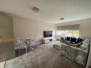 a living room with a couch and a table at HOME from HOME in Birmingham