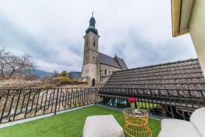 a view of a church from the balcony of a house at Haus mit Donaublick, Terrasse und Garten in Dürnstein