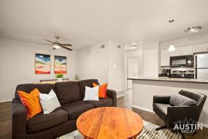 a living room with a couch and a table at Minutes to Zilker, Barton Springs and Free Parking in Austin