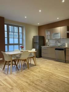a kitchen with a table and chairs in a room at T5 COEUR DE VILLE in Besançon