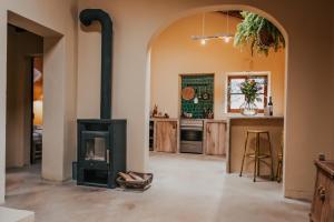 a kitchen with a stove in the middle of a room at The Lemon Lodge in Aljezur