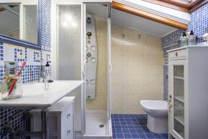 a bathroom with a shower and a sink and a toilet at Villa Mimosa 