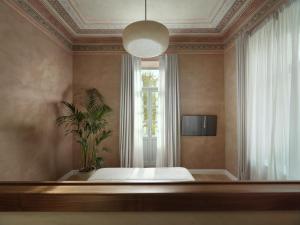 a bedroom with a bed and a window at Monument Hotel in Athens