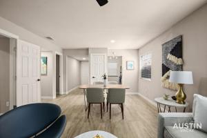 a kitchen and living room with a table and chairs at Walk to Restaurants or Cook in Subway Tile Kitchen in Austin