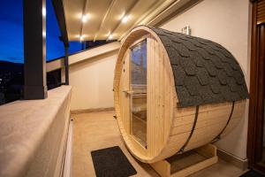 a small wooden hobbit house with a large window at Exclusive Penthouse Old town with sauna and jacuzzi in Mostar