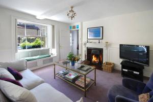 a living room with a couch and a fireplace at Charming Cottage in the Heart of Frome - Sun House in Frome