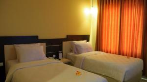 Ένα ή περισσότερα κρεβάτια σε δωμάτιο στο M Hotel