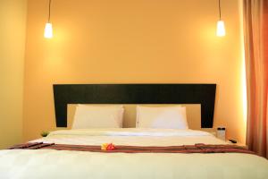 Ένα ή περισσότερα κρεβάτια σε δωμάτιο στο M Hotel
