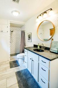 a bathroom with a sink and a toilet and a mirror at Spacious Country Home Near Ft Sill and Medicine Park in Lawton
