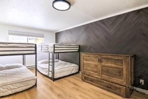 a bedroom with two bunk beds and a wall at The Cottages Chic Ski-InandSki-Out Mountain Condo! in Beaver