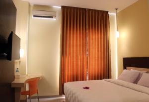 Postel nebo postele na pokoji v ubytování M Hotel