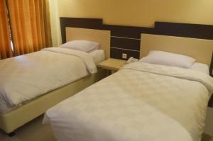 Ένα ή περισσότερα κρεβάτια σε δωμάτιο στο M Hotel