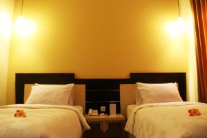 Ένα ή περισσότερα κρεβάτια σε δωμάτιο στο M Hotel