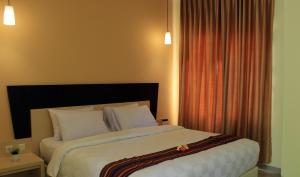Ένα ή περισσότερα κρεβάτια σε δωμάτιο στο M Hotel