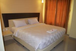 Ένα ή περισσότερα κρεβάτια σε δωμάτιο στο M Hotel