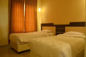 Ένα ή περισσότερα κρεβάτια σε δωμάτιο στο M Hotel