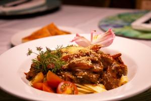 a plate of food with meat and vegetables on a table at Cartagena Royal Hotel Boutique in Cartagena de Indias