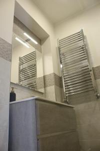 a bathroom with two mirrors on the wall and a sink at casa bea in Aci Castello