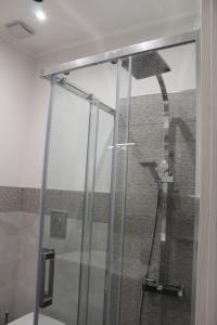 a shower with a glass door in a bathroom at casa bea in Aci Castello