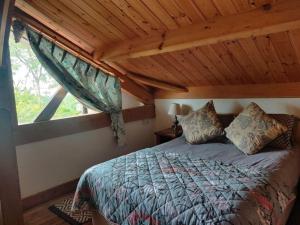 a bedroom with a large bed with a window at Kingsford renovated old cottage in Wexford