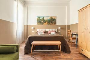 a bedroom with a bed and a table in it at Dante Suites in Palermo