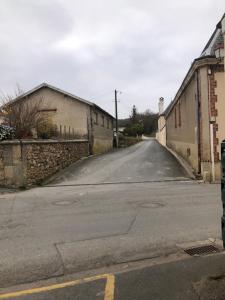 an empty street next to a brick building at L'escapade champenoise in Villers-Marmery