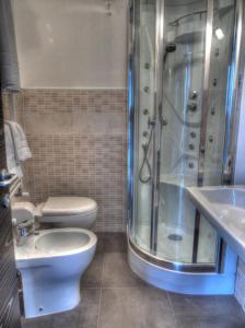 a bathroom with a shower and a toilet and a sink at B&B Il Belvedere Viggiano in Viggiano
