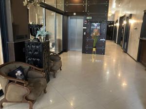 a lobby with chairs and a vase of flowers at Joy Apartment Sunny Beach in Sunny Beach +36 photos