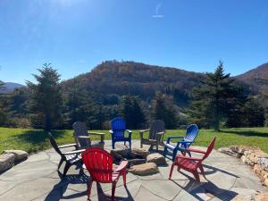 a group of chairs sitting around a fire pit at Hilltop Haven in Boone