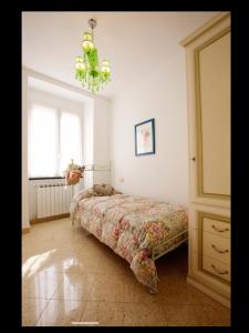 a bedroom with a bed and a chandelier at Casa Gelsomino in Levanto