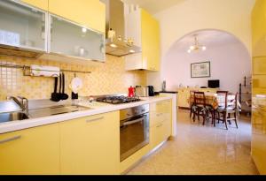 a kitchen with a sink and a stove top oven at Casa Gelsomino in Levanto