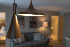 a lamp in a living room with a couch at LakeSide Apartments Seefeld in Seefeld in Tirol