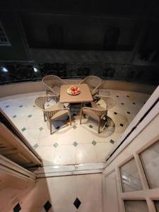 a table and chairs with a bowl of fruit on it at HK Pyramids Guest House Hospitality& Kindness in Cairo