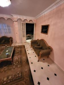 a living room with a couch and a table at HK Pyramids Guest House Hospitality& Kindness in Cairo