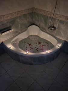 a bath tub filled with confetti in a bathroom at HK Pyramids Guest House Hospitality& Kindness in Cairo +33 photos