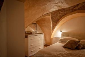 a bedroom with a bed and a dresser at La Corte GIO' in Taurisano